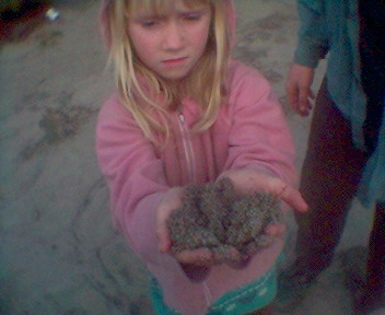 Ciela holding a handful of ash.